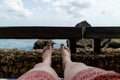 Looking at a man`s legs relaxing by the sea Royalty Free Stock Photo