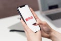 Women Holding Netflix App on iPhone 11 Mockup download