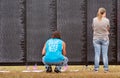 Looking at names on the Vietnam memorial wall