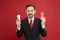 Looking for new ideas. Power saving. Male in business outfit. Businessman in suit hold light bulb. Electricity and
