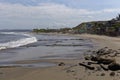 Looking North along the wide curving beach of Mancora with the tide out and waves crashing ashore Royalty Free Stock Photo