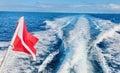 Boat Wake Serenity: Trailing Dive Flag on Open Waters