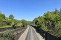 Godley Road, with high stone walls, and trees near, Halifax,Yorkshire, UK Royalty Free Stock Photo