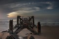 Looking out at Broken old structure remains of pier in the during beautiful twilight in the sea