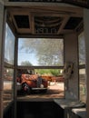 Looking out from an old phone booth at vintage cars Royalty Free Stock Photo