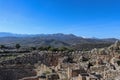 Looking out over the hill fort at Mycenae Greece and the museum and parking lot and over farmland and olive groves to the