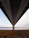 Looking out over the river underneath the road deck of the Humber Bridge single span suspension bridge Royalty Free Stock Photo