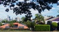 Looking out over the rooftops of Brisbane suburban house with solar panels to the downtown skyline in the distance framed by the Royalty Free Stock Photo