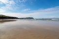 Looking out over the sandy beach at Polzeath in Cornwall, with a blue sky overhead Royalty Free Stock Photo