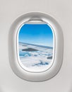 Looking out the window of a plane to the aircraft wing and cloud Royalty Free Stock Photo