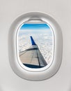 Looking out the window of a plane to the aircraft wing, clouds Royalty Free Stock Photo