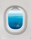 Looking out the window of a plane to the island Royalty Free Stock Photo