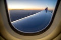 Looking outside the airplane window at sunset, holiday concept Royalty Free Stock Photo
