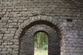Looking outside from the inside of a ruin in the forest Royalty Free Stock Photo