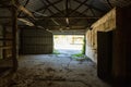 Looking outside from the inside of a dark old barn Royalty Free Stock Photo