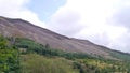 Looking over forests to hill covered in screen and rock Royalty Free Stock Photo