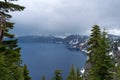 Looking over the rim into the Caldera of a volcano at Crater Lake National Park in Oregon on a stormy day Royalty Free Stock Photo
