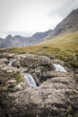 Looking over the rocks of the waterfalls towards the Cullins from the Fairy Pools on Skye Royalty Free Stock Photo