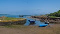 Looking over the rocky harbour to the old jetty and some small boats at Portencross in Seamill West Kilbride on a bright summers Royalty Free Stock Photo