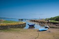 Looking over the rocky harbour to the old jetty and some small boats at Portencross in Seamill West Kilbride on a bright summers Royalty Free Stock Photo