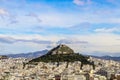 Looking over the rooftops to Lycabettus Hill - the highest spot in Athens Greece with church of St George and a resturant where to Royalty Free Stock Photo