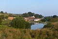 Looking over small lake to farm area