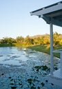 Looking at a pond from a white garden house / gazebo / arbour in Queensland, Australia during a sunset Royalty Free Stock Photo
