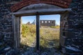 Looking at the Quincy Mine through an abandoned doorway from a building ruin Royalty Free Stock Photo