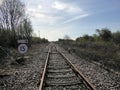 Looking down railway line with sign and turnoff Royalty Free Stock Photo