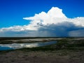 Looking at raining cloud from afar with blue sky background and Royalty Free Stock Photo