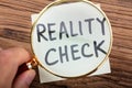 Looking At Reality Check Word Through Magnifying Glass