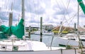 Looking through sailboat yacht masts to new house construction b