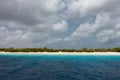 Looking at the sandy shoreline of the deserted island of Klein Bonaire from the turquoise water