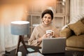 Peaceful attractive lady spending time at home and watching video