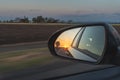 Looking through a side mirrors with a sunset in it Royalty Free Stock Photo