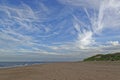 Looking south down the Ythan Estuary Beach on the East Coast of Scotland with dramatic high level clouds.