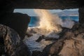 Looking through a space in the rocks to sea water crashing over rocks. La Pared, Fuerteventura