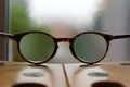 Looking through spectacles on a table with defocused background Royalty Free Stock Photo