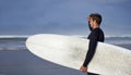 Looking, surfing and man with surfboard at beach for, waves on summer vacation, weekend and holiday by sea. Travel Royalty Free Stock Photo