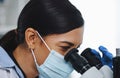 Looking at things from a different perspective. a young female researcher working in a laboratory.