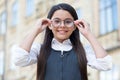 Looking to future. Happy kid fix eyeglasses outdoors. Eye sight development. Child vision. Back to school eye sight test Royalty Free Stock Photo