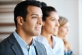 Looking towards the future. three young businesspeople standing in their office. Royalty Free Stock Photo