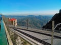 Looking at the trainstation and the surrounding mountains