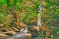 Looking through tree branches at a waterfall