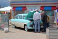 Looking under the hood of a classic car.