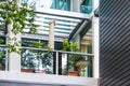 Looking up al elegant modern balcony with interesting archetecture and potted plants and an umbrella