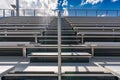 Looking up at anticipation of climbing exterior stadium bleacher stairs with a sun star near the top