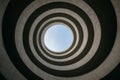Spiral architecture creates a stunning view of the sky from below in a unique urban setting Royalty Free Stock Photo