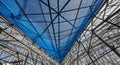 Looking up at a blue safety net stretched over a metal construction framework blue net Royalty Free Stock Photo