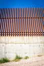Looking up at border wall between united states and mexico Royalty Free Stock Photo